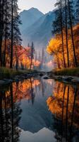 Vibrant autumn foliage reflected in a serene mountain river at dawn photo