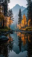 Autumn morning reflecting serene mountains and golden trees by a tranquil stream in nature's untouched beauty photo