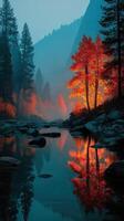 Autumn trees reflect in tranquil river surrounded by misty mountains at dusk photo