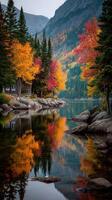 escénico otoño ver de vistoso arboles reflejado en calma lago en montañoso paisaje foto