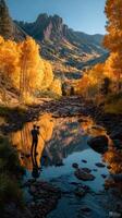 Vibrant autumn colors reflect in calm mountain stream at sunset in a serene forest landscape photo