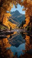 Capturing autumn beauty in a serene river landscape with vibrant yellow trees and mountain reflections photo