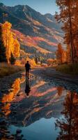 Photographer capturing autumn colors in a serene mountain landscape during golden hour photo