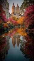 Stunning autumn view of Central Park with vibrant trees and twin towers reflected in the calm water photo