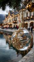 Decorative ornament reflecting beautiful festive lights by the water in a charming village during winter photo