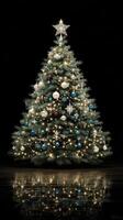 Elegant Christmas tree adorned with white and blue ornaments illuminated against a dark background photo