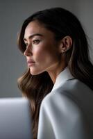 Woman in profile looking contemplative by a window photo