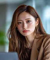 Young woman poses confidently in a modern workspace photo