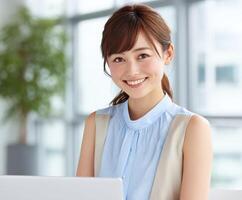 Young professional woman smiles while working in modern office photo