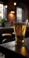 Refreshing glass of beer on a wooden table in a cozy bar photo