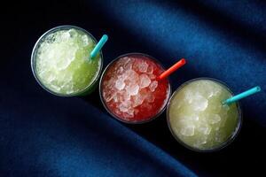 Colorful slush drinks displayed on a blue surface photo