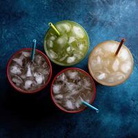 Ice-cold beverages served in colorful cups with straws photo