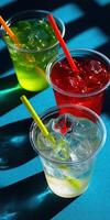 Refreshing colorful drinks on a vibrant surface in sunlight photo