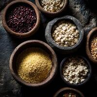 Colorful collection of grains and legumes in rustic bowls photo