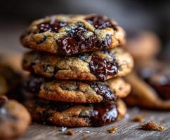 Warm chocolate chip cookies stacked on a wooden table photo