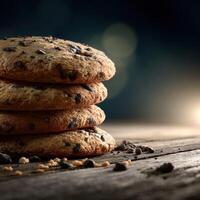 Stack of chocolate chip cookies on wooden table with dark background photo