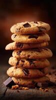 Chocolate chip cookies stacked in a warm kitchen setting photo