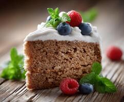 Delicious slice of cake topped with berries and mint leaves photo
