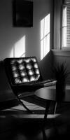 A black and white photo of a leather chair