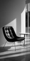 A black and white photo of a chair in a room