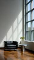 A black leather couch in front of large windows photo