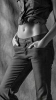 Woman showcasing stylish jeans in monochrome setting photo