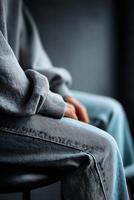 Casual moment captured in faded jeans and a cozy gray sweater photo