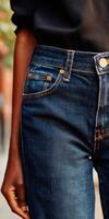 Stylish close-up of jeans in an urban setting during daylight photo