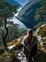Viking woman gazing at fjord landscape in stunning natural setting photo