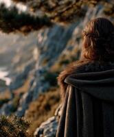 Viking woman overlooking a serene landscape at dawn in Scandinavia photo