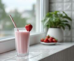 Refreshing strawberry protein shake on a cozy kitchen windowsill photo
