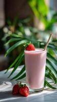 Refreshing protein shake with strawberries in a natural setting photo