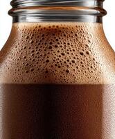 Protein shake in glass jar with frothy texture, ready for consumption photo