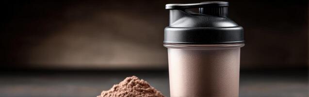 Protein shake preparation with powdered mix and shaker in dim lighting photo
