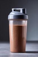 Protein shake in a clear shaker on a minimalist background photo
