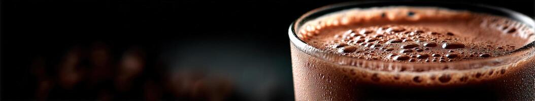 Delicious chocolate protein shake in glass against dark background photo