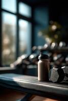 Protein shake next to weights in a bright gym setting during the day photo