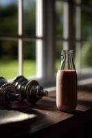 Protein shake on a wooden table beside weights in bright daylight photo