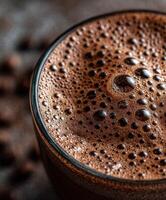 Rich chocolate protein shake served in a clear glass with bubbles photo