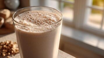 Delicious protein shake in a glass by the window with natural light photo