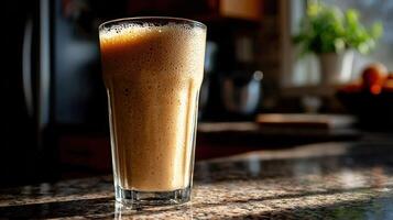 Protein shake in a glass on a kitchen counter during the morning photo