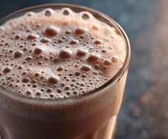 Healthy protein shake with frothy texture served in glass photo
