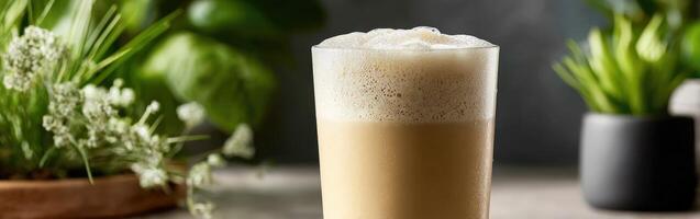 Refreshing protein shake served in a clear glass with greenery photo