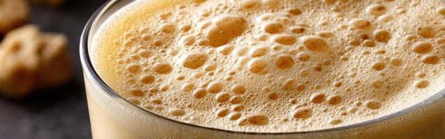 Protein shake filled with bubbles served in a glass on a table photo