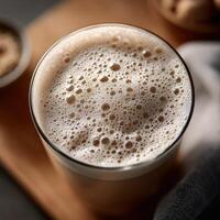 Protein shake with frothy texture served in a clear glass photo