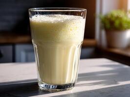 Delicious protein shake in a glass on a kitchen countertop photo