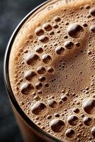 Delicious protein shake with frothy texture in glass close up photo