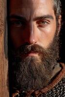 Intense portrait of a bearded man in medieval attire photo