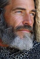 Man in chainmail with a thoughtful expression outdoors photo