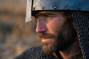 Warrior in shining helmet during sunset at the battlefield photo